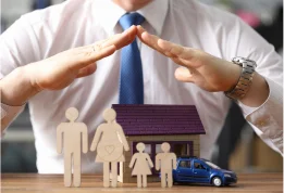 Man with hands over family standing outside of their home representing protection