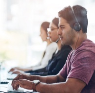 Customer support team working at computers, representing how to effectively manage BPO operations and client service.