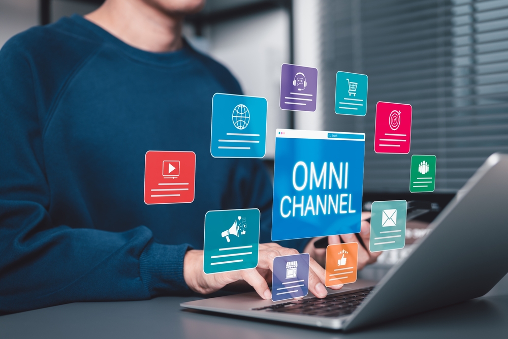 Omni Channel Digital Marketing and E-Commerce concept. Businessman with omni-channel market icon, customer engagement, online sales, print ads, website, social media, call center, email, store, mobile.