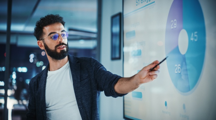 Professional presenting business data on a screen to support business growth strategies and company success.