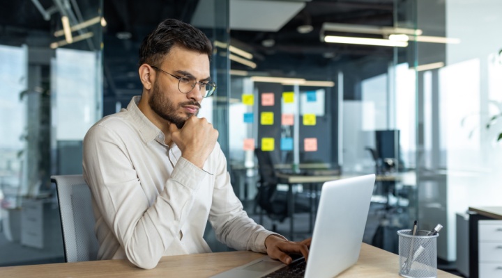 Professional working at a laptop in an office, showing how BPO can help your team improve productivity and efficiency.
