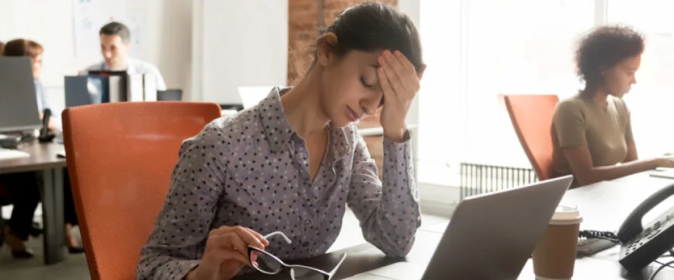 Female worker burnout sitting at desk at work