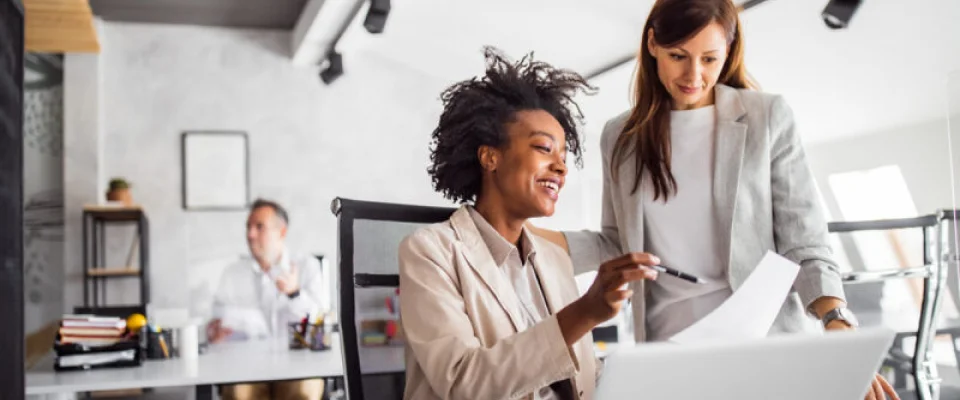 Two brunette business woman, talking, advising each other