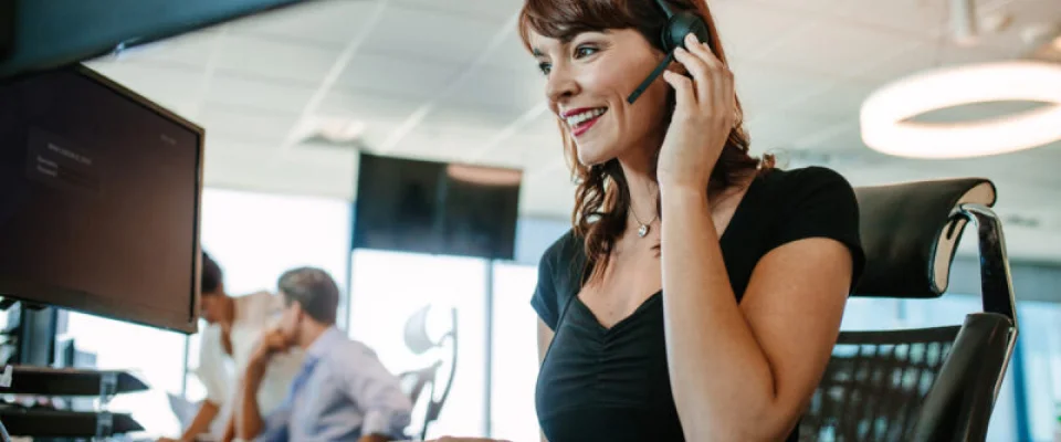 smiling female call center agent taking calls