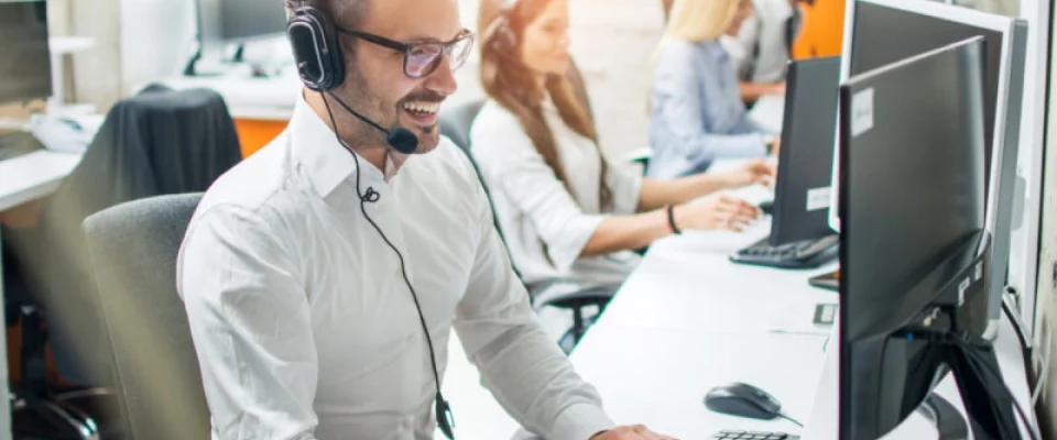 smiling customer service rep on computer