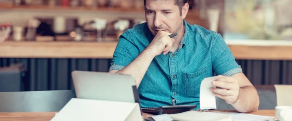 business owner looking at reciept and computer