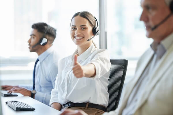Customer support agents wearing headsets work together in a bright call center, showing ways Business Process Outsourcing helps businesses scale faster with dependable team support.