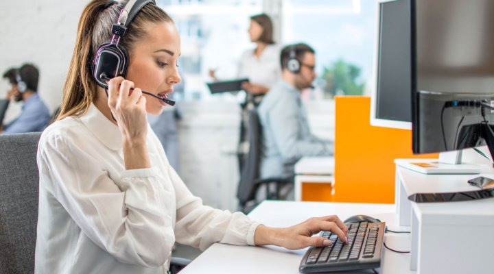 woman with headset on in call center
