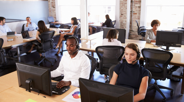 call center agents sitting in office on computers