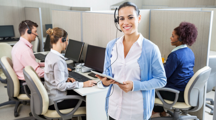 Call center manager stands in front of call center workers