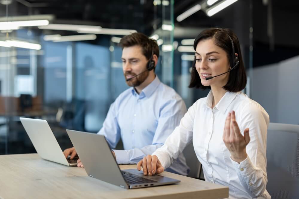 Two BPO agents work with clients for a medical practice with claims, billing, appointments.