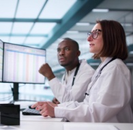 Medical team reviewing patient data on screens in a modern office for outsourcing medical billing services-1