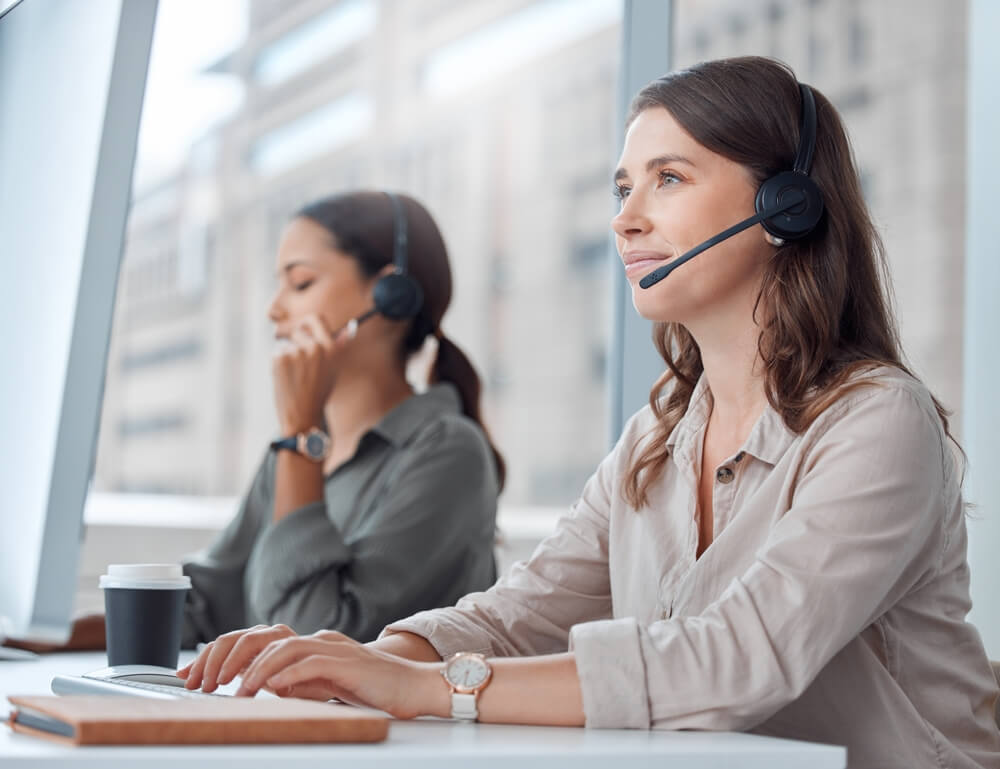 Two call center agents take care of real estate customers.