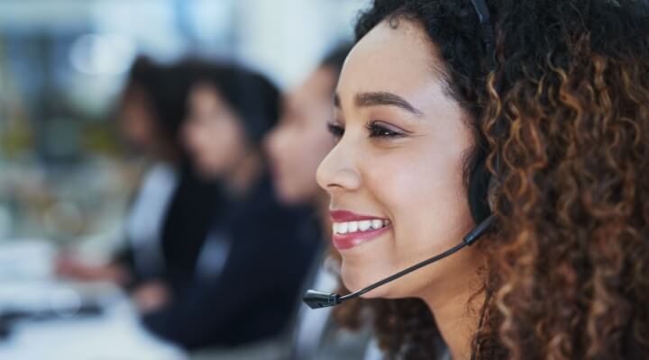 Woman, office and happy in call center for customer support, consulting and outbound telemarketing for sales. Girl, consultant and headphones for communication, listening and contact us for advice.