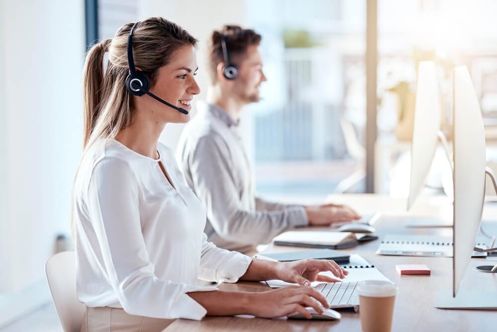 Call center, direct response marketing, with woman in office for customer service, technical support and advice. Technology, contact us and communication with employee operator in nearshore call center.