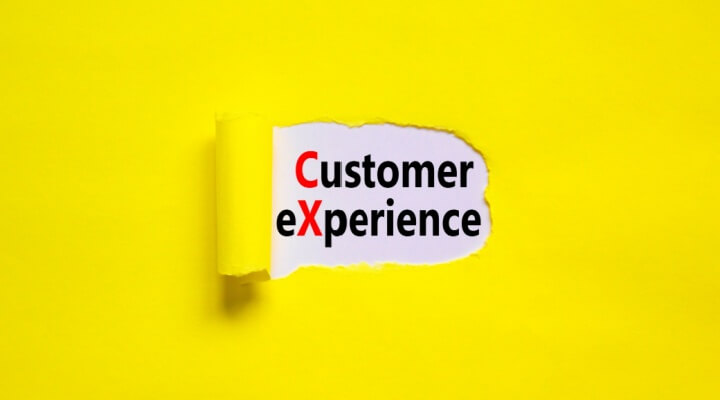 Piece of yellow paper curls back to reveal the importance of CX and how BPO can help.
