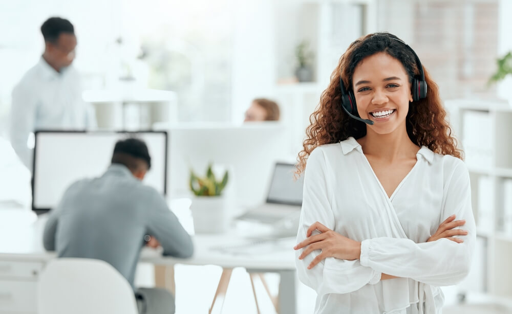 Smiling call center agent works at BPO to insure the customer experience for the clients is highly ranked.
