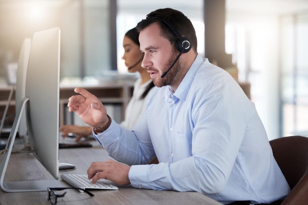 Call center, lead generation, consulting and computer with man in office for communication, customer service or help desk. Telemarketing, sales and advice with male employee for commitment, contact us and hotline.