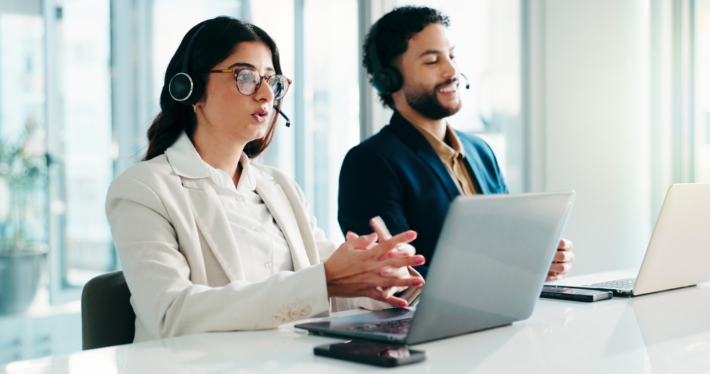 Laptop, consulting man and woman in call center for sales, insurance and lead generation. Computer, telemarketing agent and communication for outbound marketing, coworking or follow up question for B2C and B2B. 