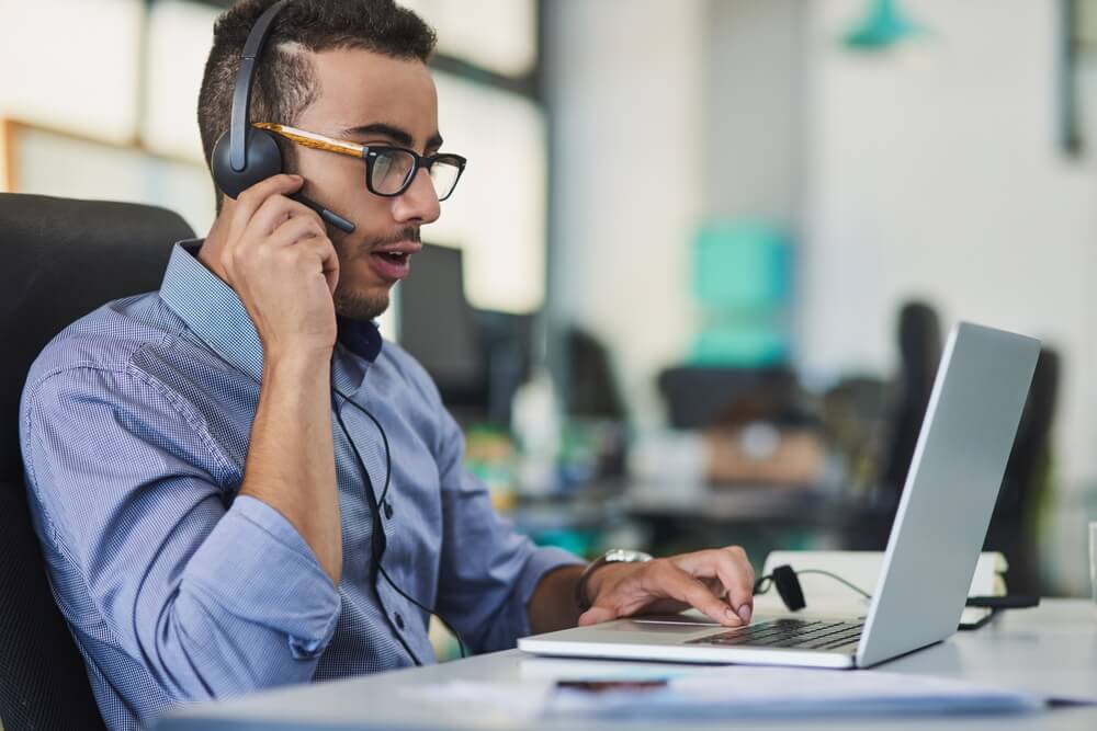 Technical support, laptop and man consultant for outsourced services for businesses. Headset, contact us and male call center agent with computer for internet crm consultation.