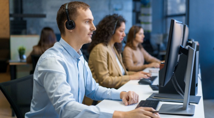 Diverse group of people working at call center in BPO claims management.