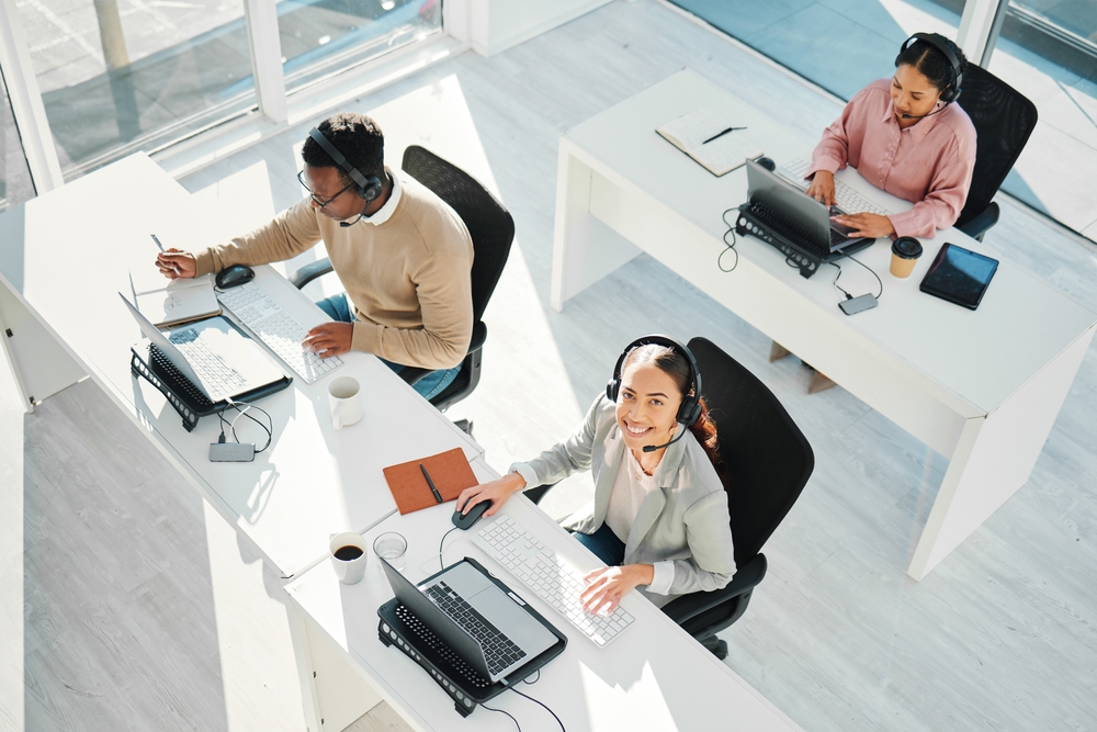 Call center, woman and smile in portrait with laptop, BPO in claims management staff and voip tech from above. Help desk agent, computer and customer service for contact us, technical support, claims and consulting.