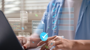 Hands using a laptop with digital invoices and checkmarks, representing secure payment processing and billing management 1