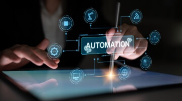 Person uses a stylus on a digital screen with an “Automation” interface and connected tech icons, representing hyperautomation in BPO.