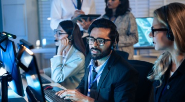 Professional reviewing digital marketing analytics on a laptop, illustrating BPO for the entertainment industry and ad performance management-1