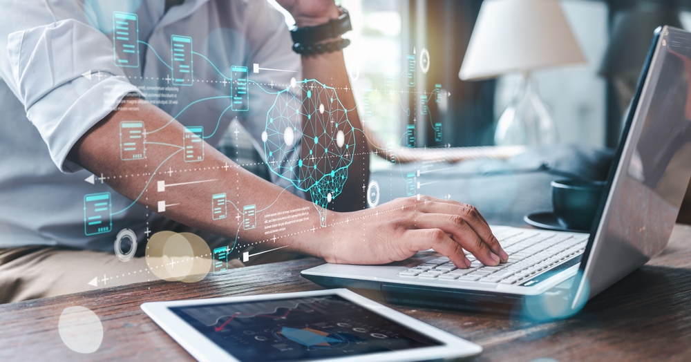 Outsourced call center technology concept showing an agent working on a laptop with digital data interfaces and AI network overlays, representing customer support, automation, and analytics in a modern outsourced call center environment.