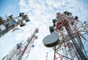 Low angle of three telecommunications towers.