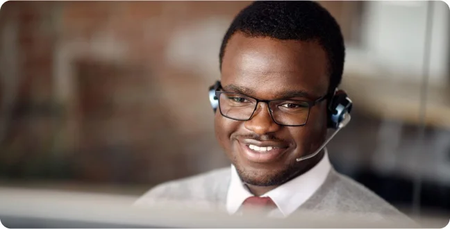 African American male call center agent smiling.