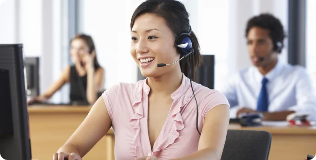 Young asian woman answering call in a call center background.