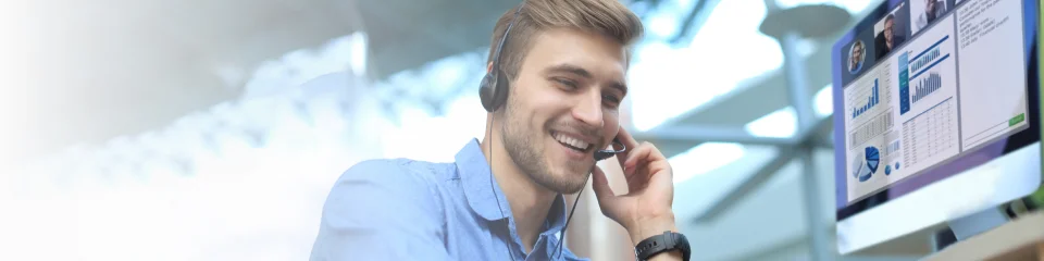 Blond man smiling while answering customer service calls