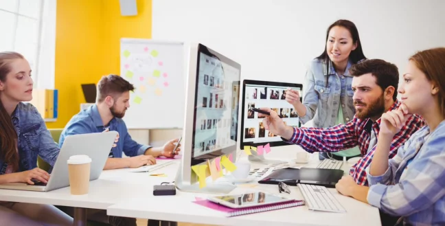 Side view of young people working in a modern office.