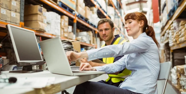 Business couple in a warehouse.