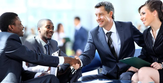 Businessmen shake hands and end a meeting